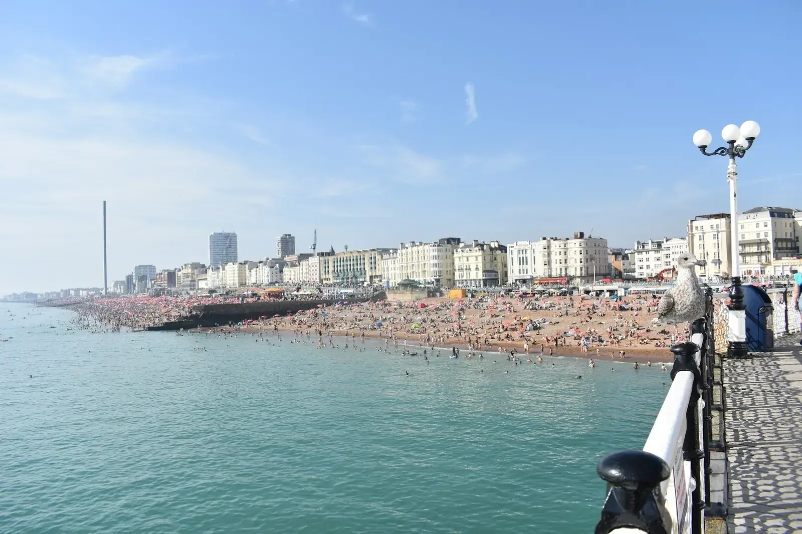 Brighton seafront and beach seen from the pier on a sunny day